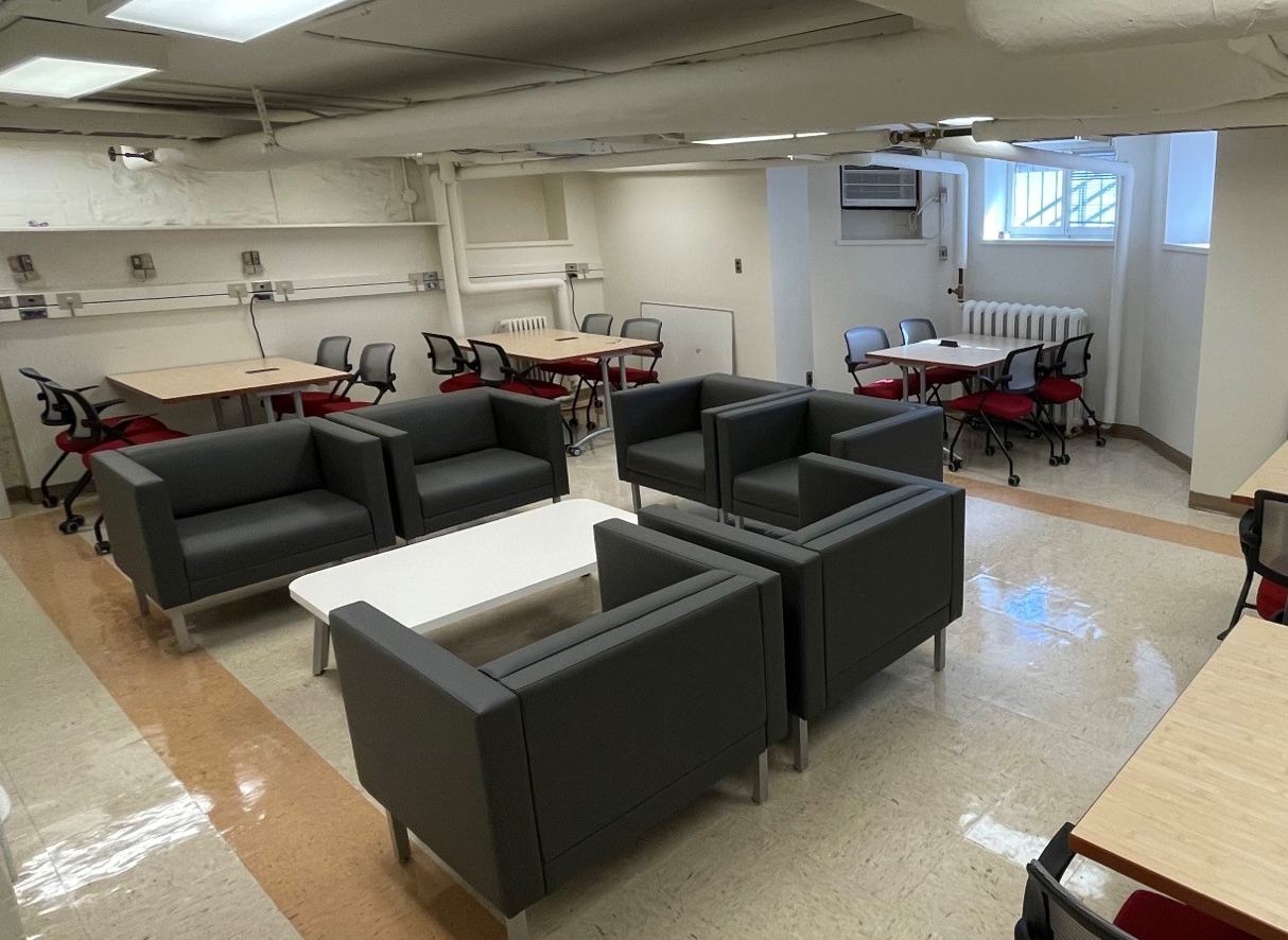 Basement space with tables and armchairs