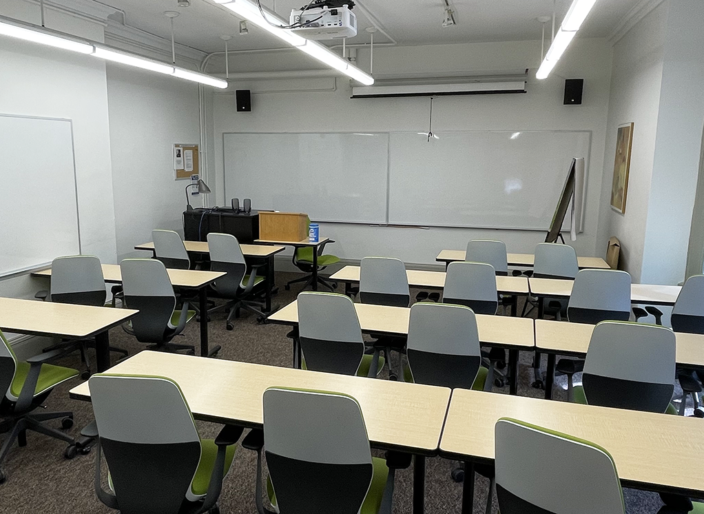 classroom with white chairs and a whiteboard