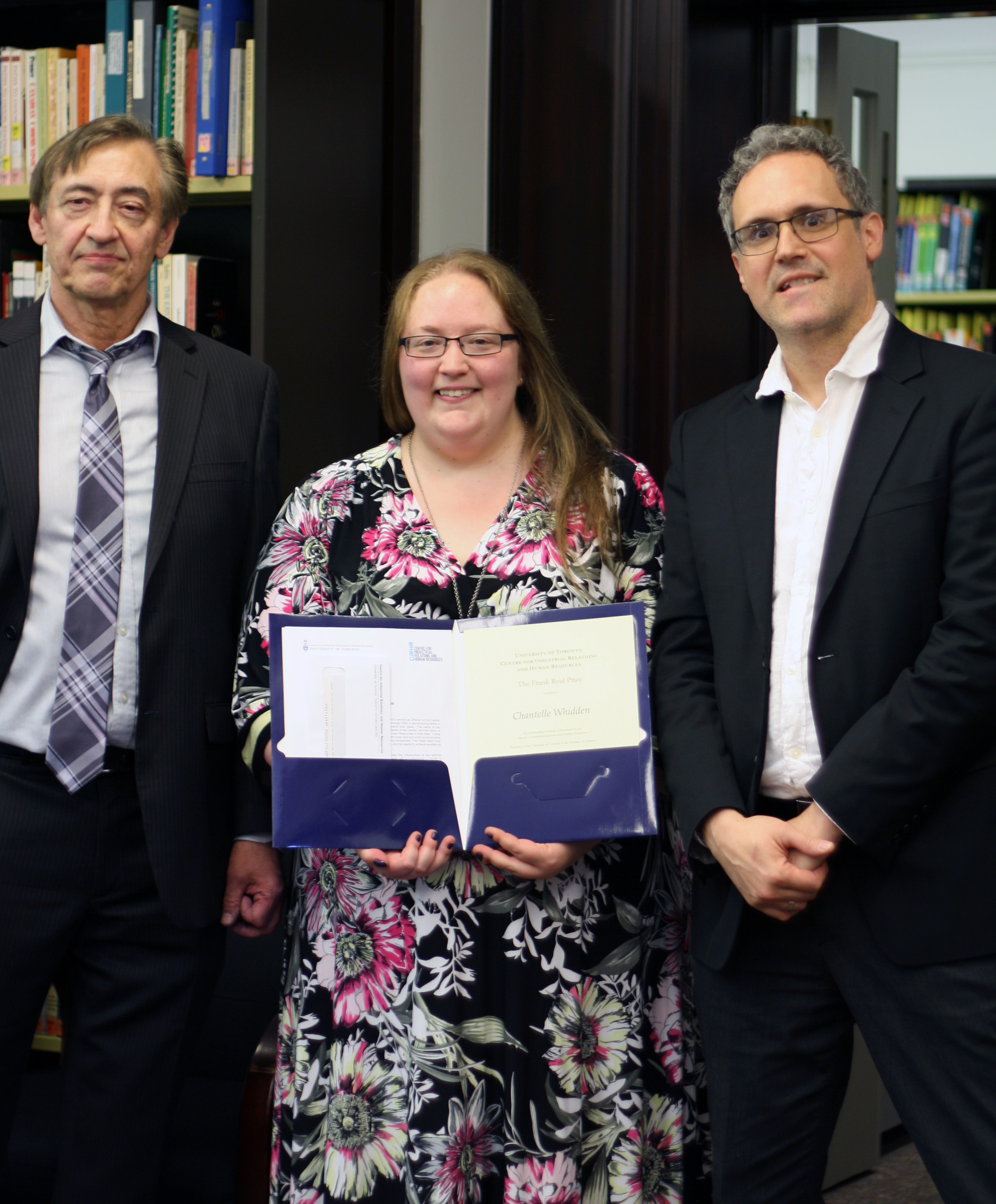 Frank Reid, Chantelle Whidden, and Rafael Gomez pose with the Frank Reid Prize