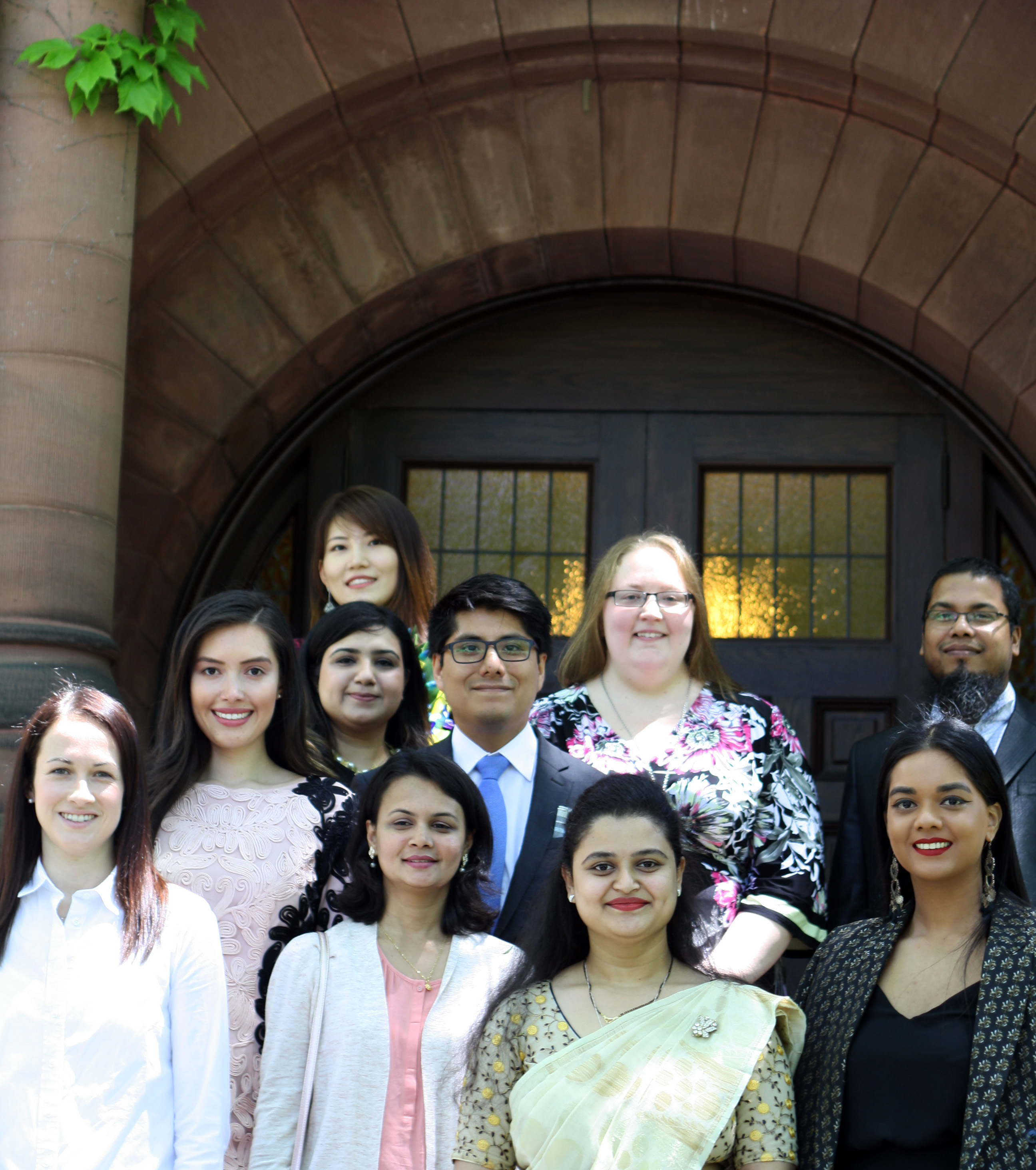 Graduates stand on the steps of the CIRHR building