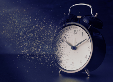 A photograph of a clock in the process of disintegrating.