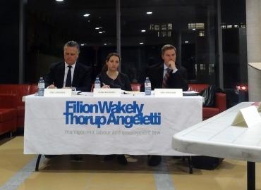 Judges sit at a table labeled Filion Wakely Thorup Angeletti 