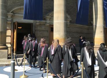 Graduating students file into Convocation Hall in their regalia