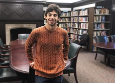 Justin Zelnicker stands in the CIRHR library