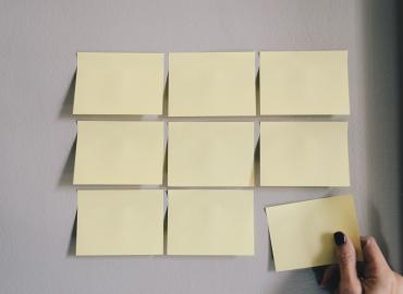 Six blank sticky notes on a wall